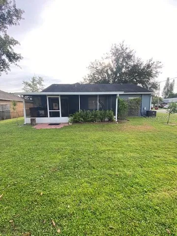 a view of a house with a yard and sitting area