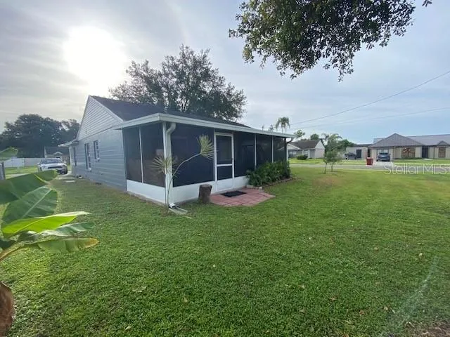 a view of a house with a yard and sitting area