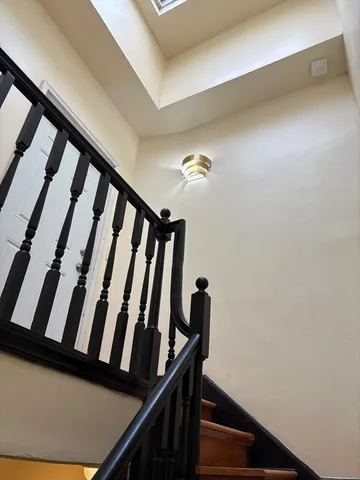 a view of staircase with large white walls
