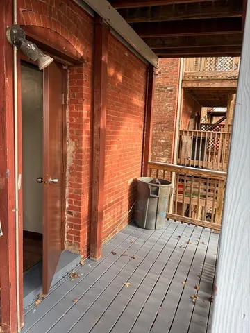 a view of balcony with wooden floor