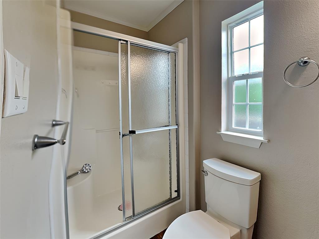 1414 Record Crossing Road Dallas, TX 75235 - Photo 11 of 15 Bathroom with a shower with shower door and toilet