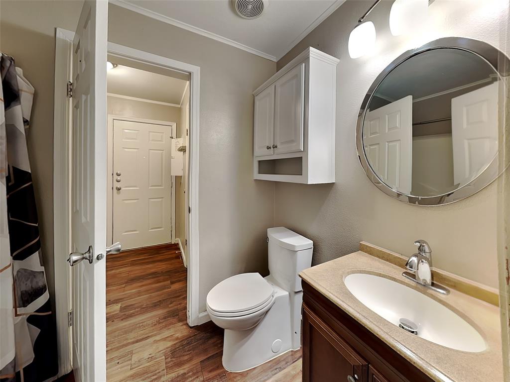 1414 Record Crossing Road Dallas, TX 75235 - Photo 15 of 15 Bathroom with crown molding, wood finished floors, and vanity