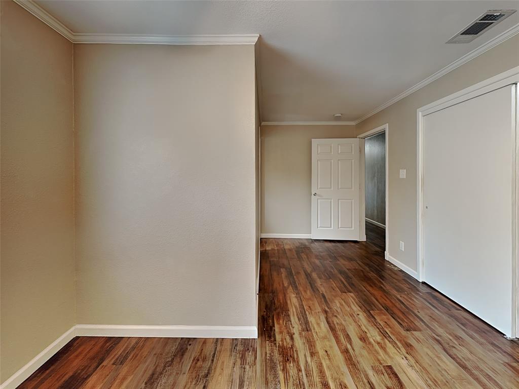 1414 Record Crossing Road Dallas, TX 75235 - Photo 8 of 15 Empty room with wood finished floors and crown molding