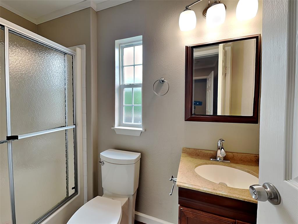 1414 Record Crossing Road Dallas, TX 75235 - Photo 10 of 15 Bathroom with vanity and bath / shower combo with glass door