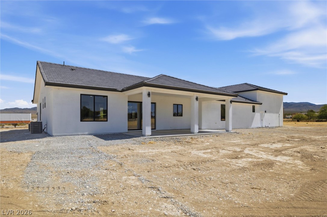 5910 East Kellogg Road Pahrump, NV 89061 - Photo 42 of 58 A new construction residence showcases contemporary design against a desert landscape.