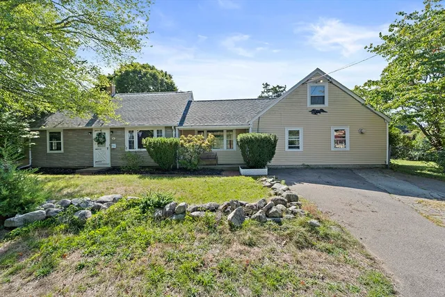 a front view of a house with a garden