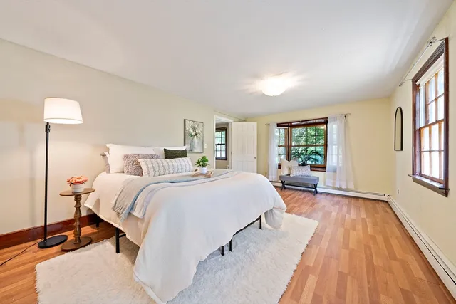 a spacious bedroom with a bed and a window