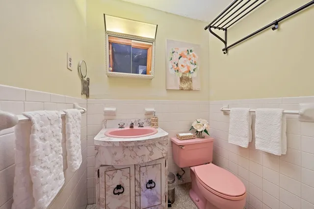 a bathroom with a sink a toilet and a shower curtain