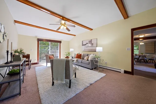 a living room with furniture and a floor to ceiling window