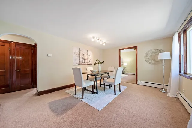 a view of a livingroom with furniture and a dining table