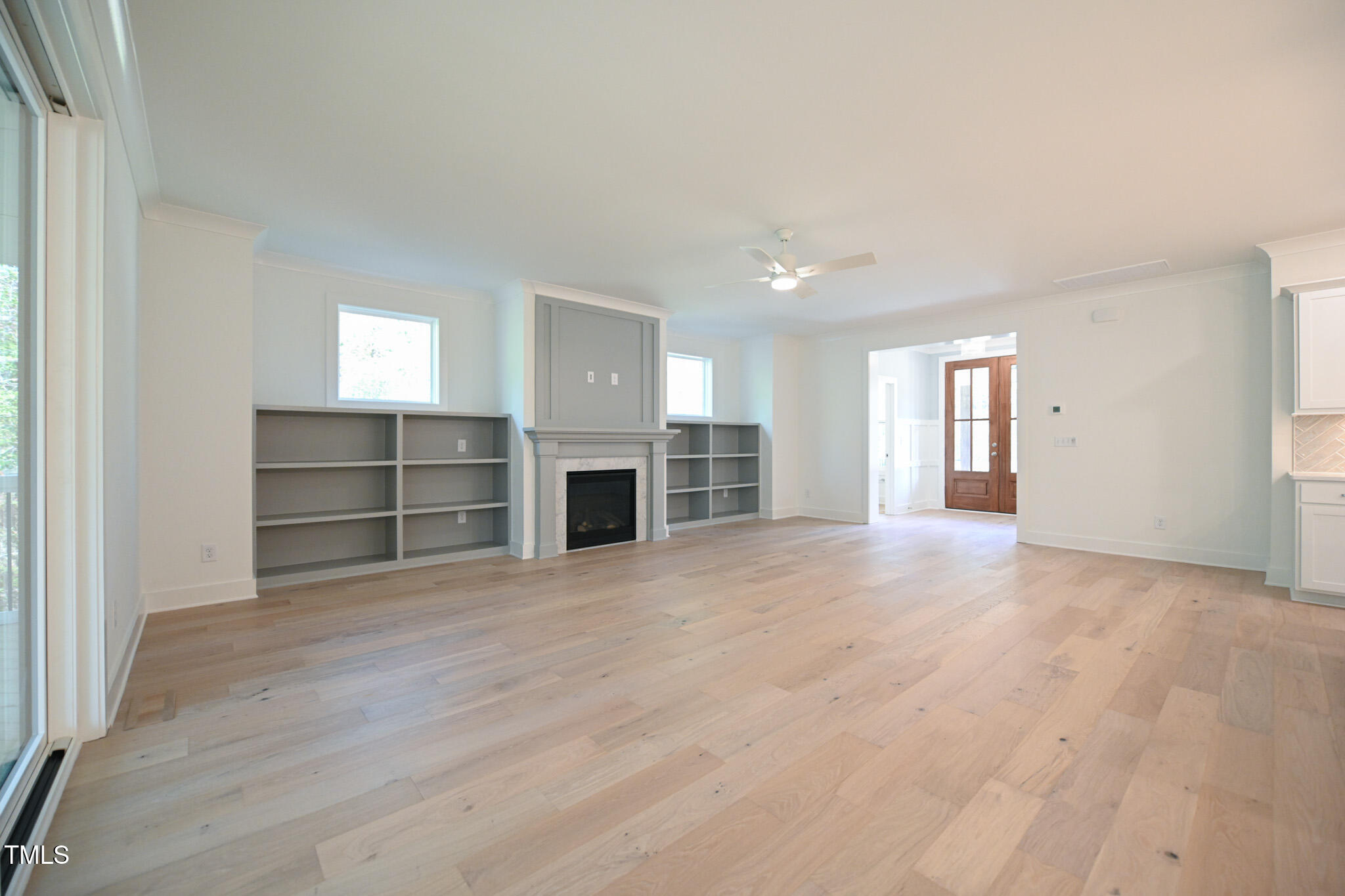 170 Sallyport Court Raleigh, NC 27603 - Photo 11 of 47 a view of an empty room with a fireplace and a window