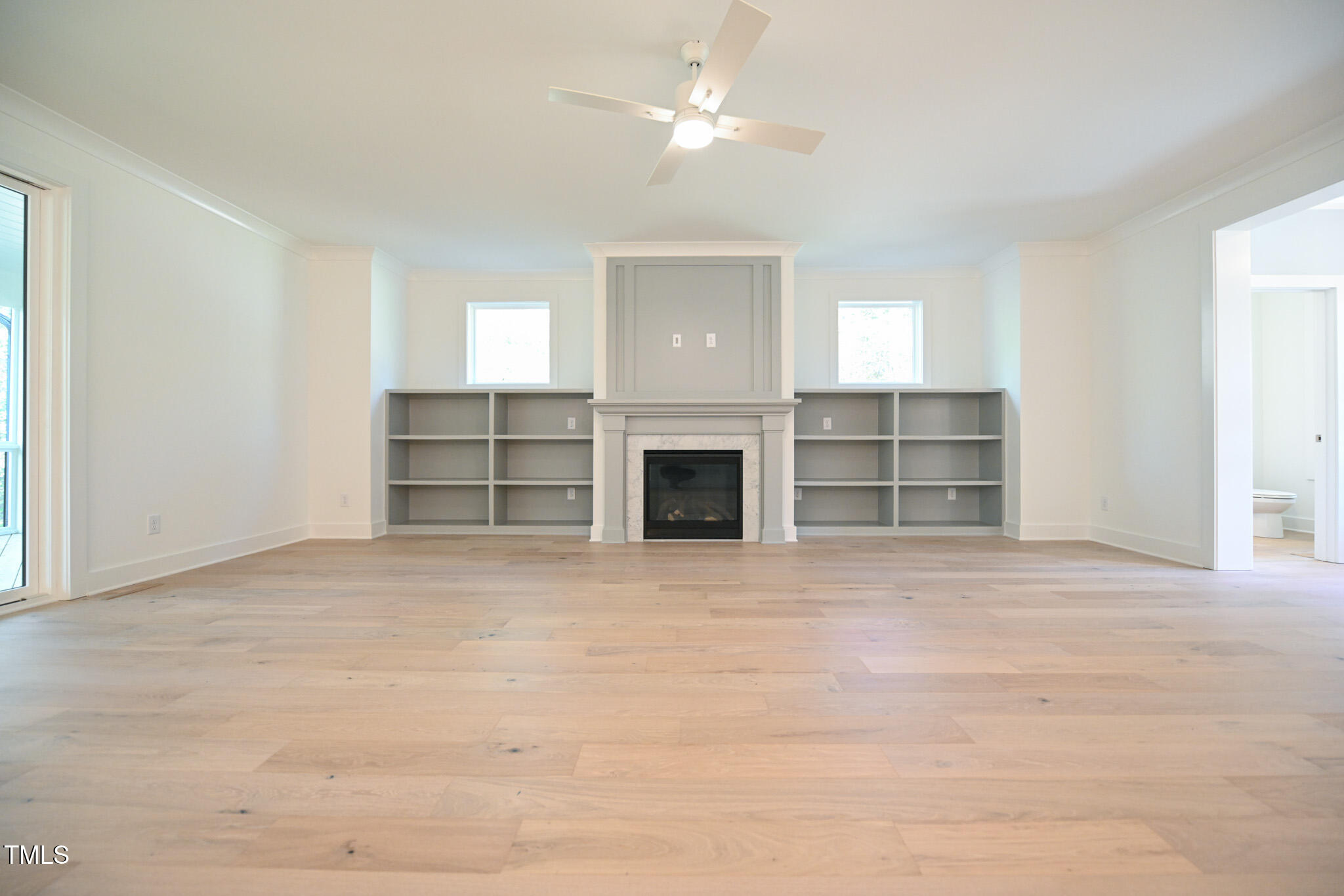 170 Sallyport Court Raleigh, NC 27603 - Photo 10 of 47 a view of an empty room with a fireplace and a window