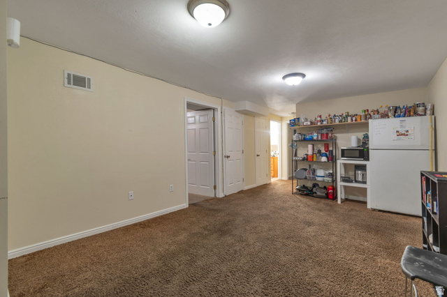 7466 Washington Road Magna, UT 84044 - Photo 14 of 21 Brown carpeted flooring throughout