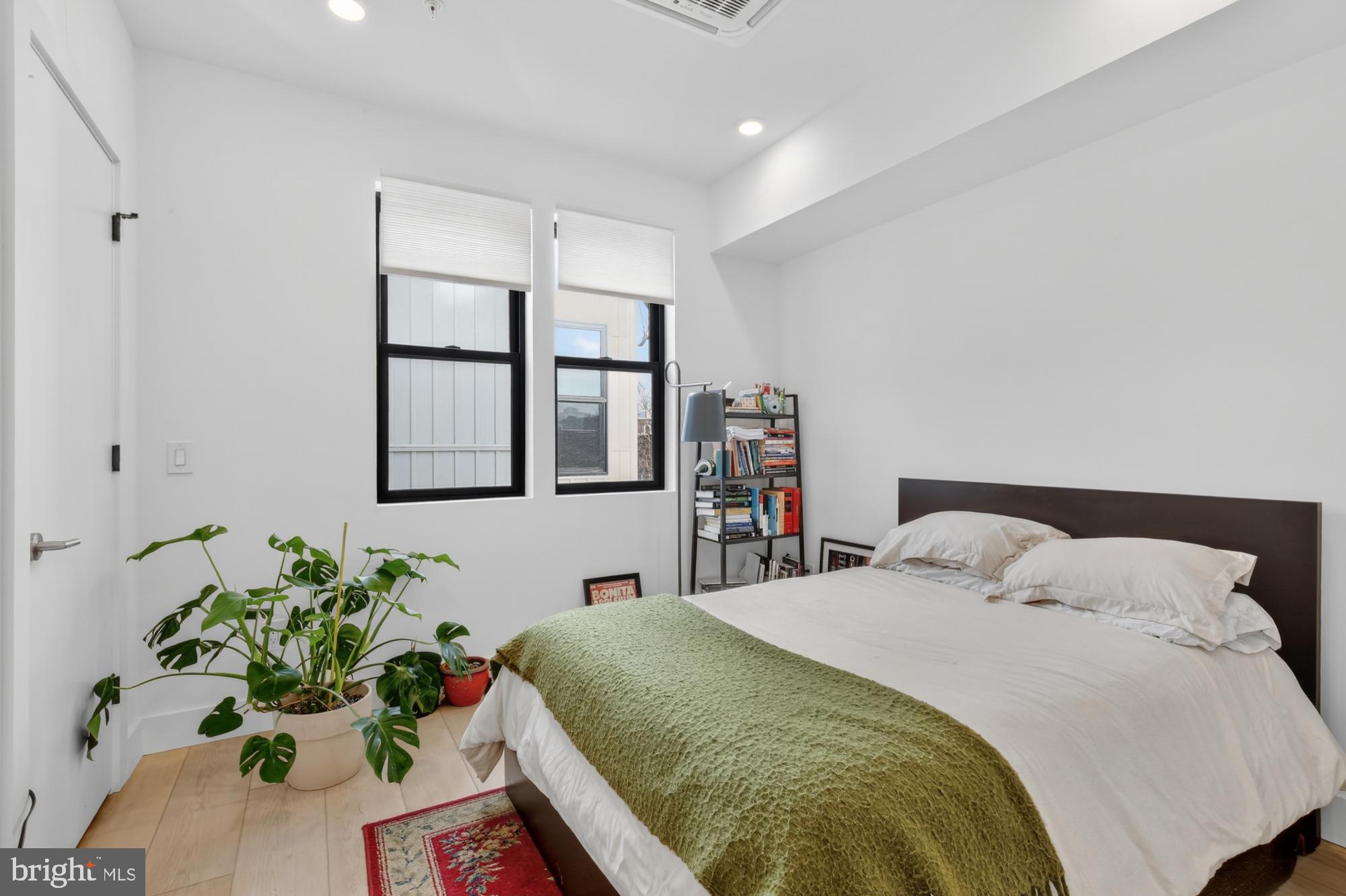 2007 Cambridge Street, Unit 9 Philadelphia, PA 19130 - Photo 12 of 33 a bedroom with a bed table and a potted plant