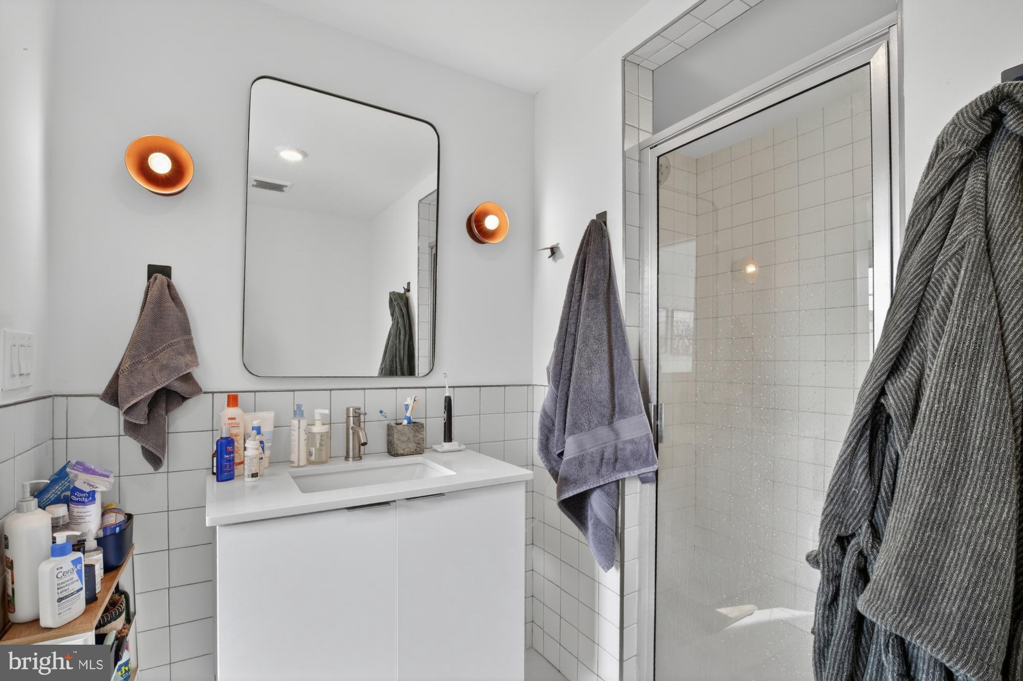 2007 Cambridge Street, Unit 9 Philadelphia, PA 19130 - Photo 21 of 33 a bathroom with a sink vanity and a mirror