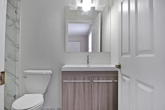 a bathroom with a toilet and a shower