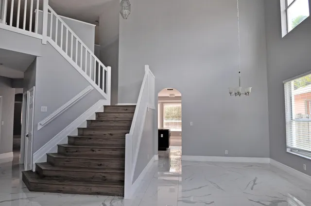 a view of entryway and hall with wooden floor