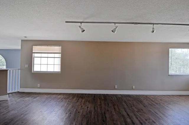 a view of a room with wooden floor and window