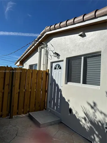 a view of a house with wooden fence