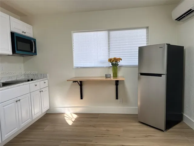 a kitchen with stainless steel appliances a refrigerator and a sink
