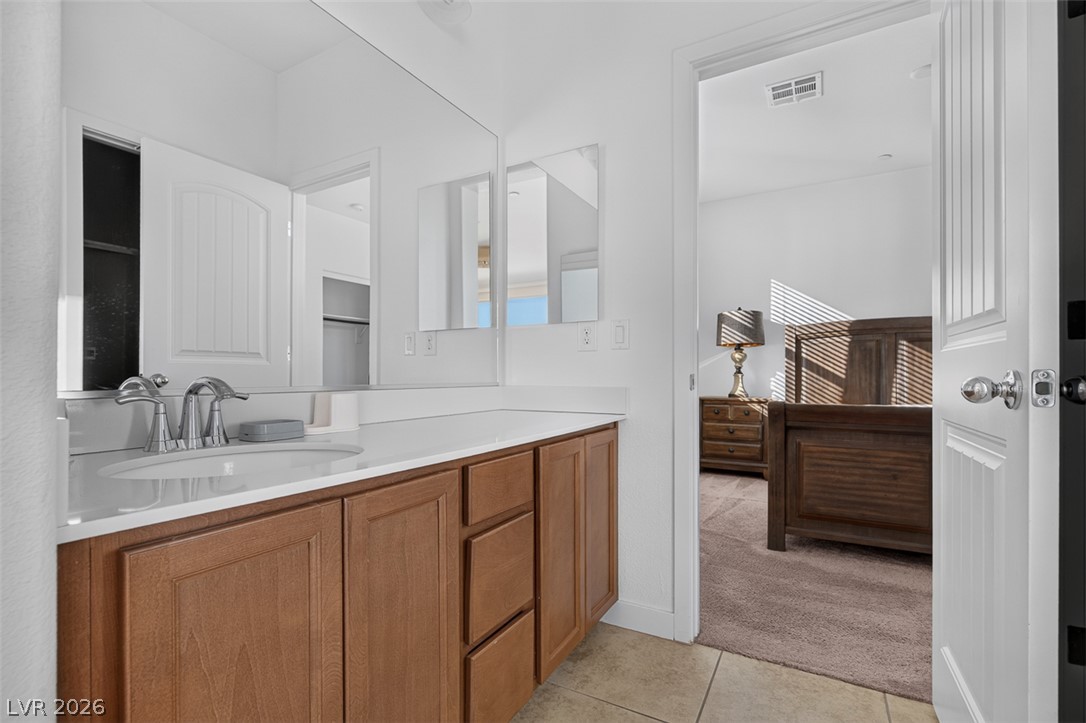 1100 East Sunset Road Henderson, NV 89011 - Photo 39 of 58 A well-appointed bathroom vanity with ample counter space and storage, connecting to a private bedroom.