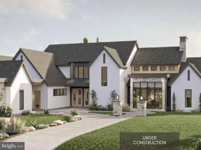 a front view of a house with a garden and plants