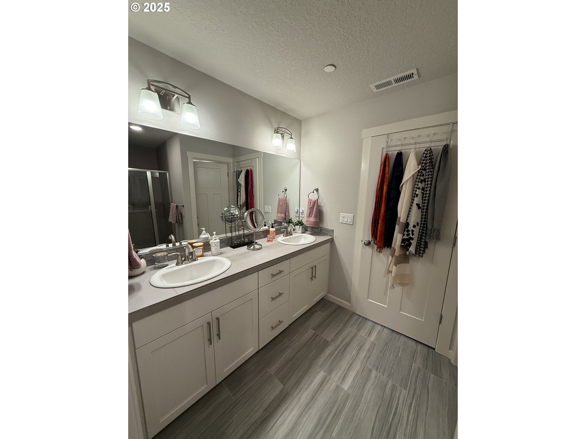 4135 South Canyon View Circle Ridgefield, WA 98642 - Photo 14 of 25 a large bathroom with a double vanity sink and mirror