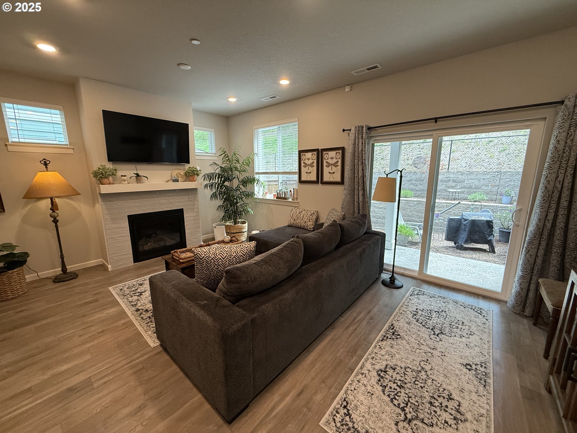 4135 South Canyon View Circle Ridgefield, WA 98642 - Photo 19 of 25 a living room with furniture a flat screen tv and a fireplace