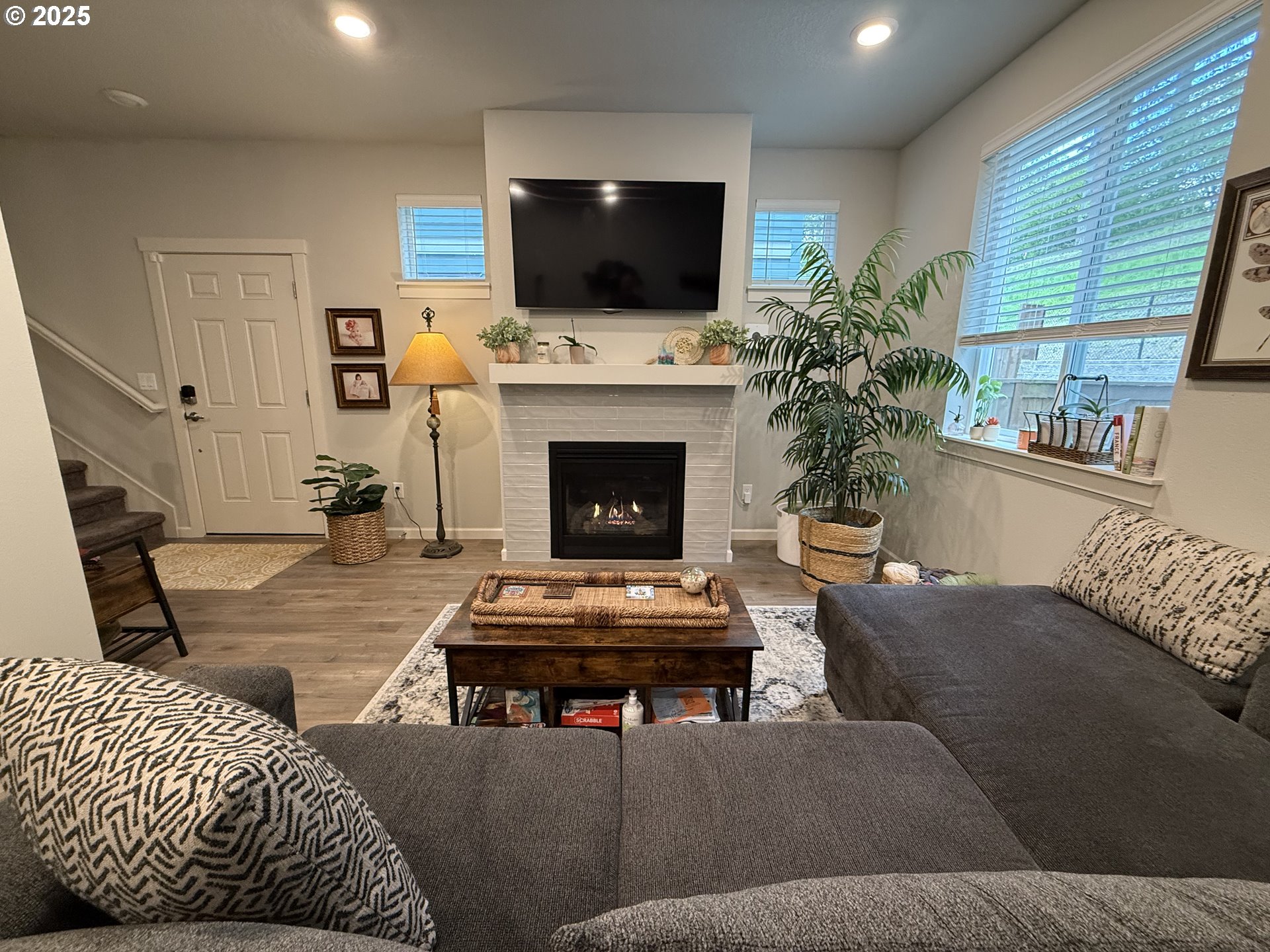 4135 South Canyon View Circle Ridgefield, WA 98642 - Photo 2 of 25 a living room with furniture a flat screen tv and a fireplace