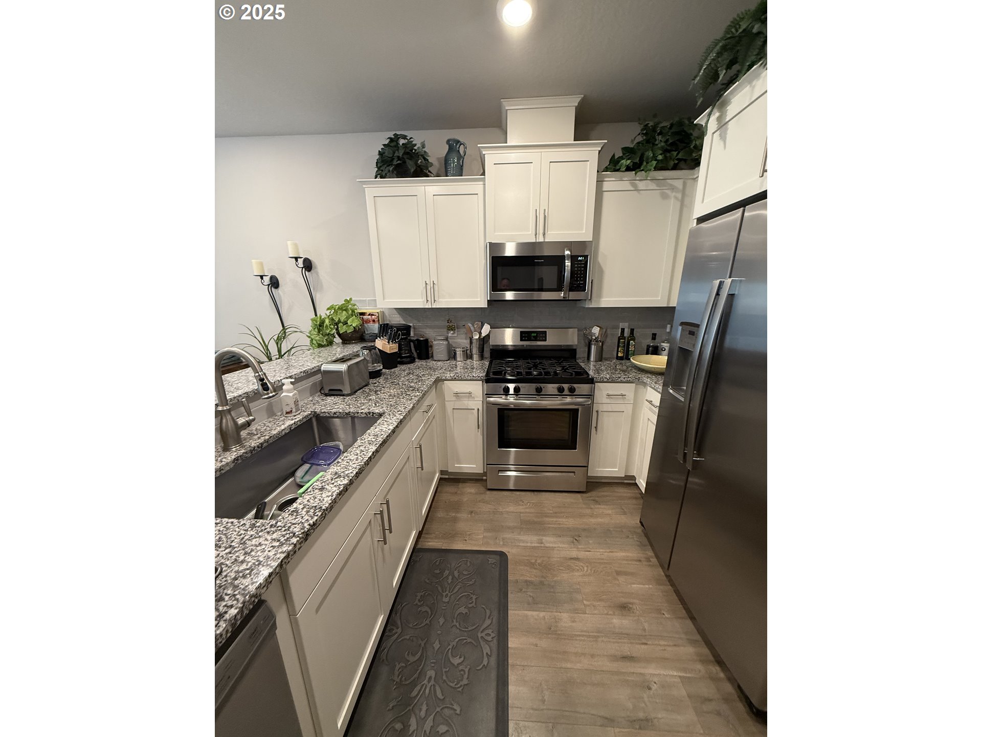 4135 South Canyon View Circle Ridgefield, WA 98642 - Photo 5 of 25 a kitchen with stainless steel appliances a sink and a refrigerator