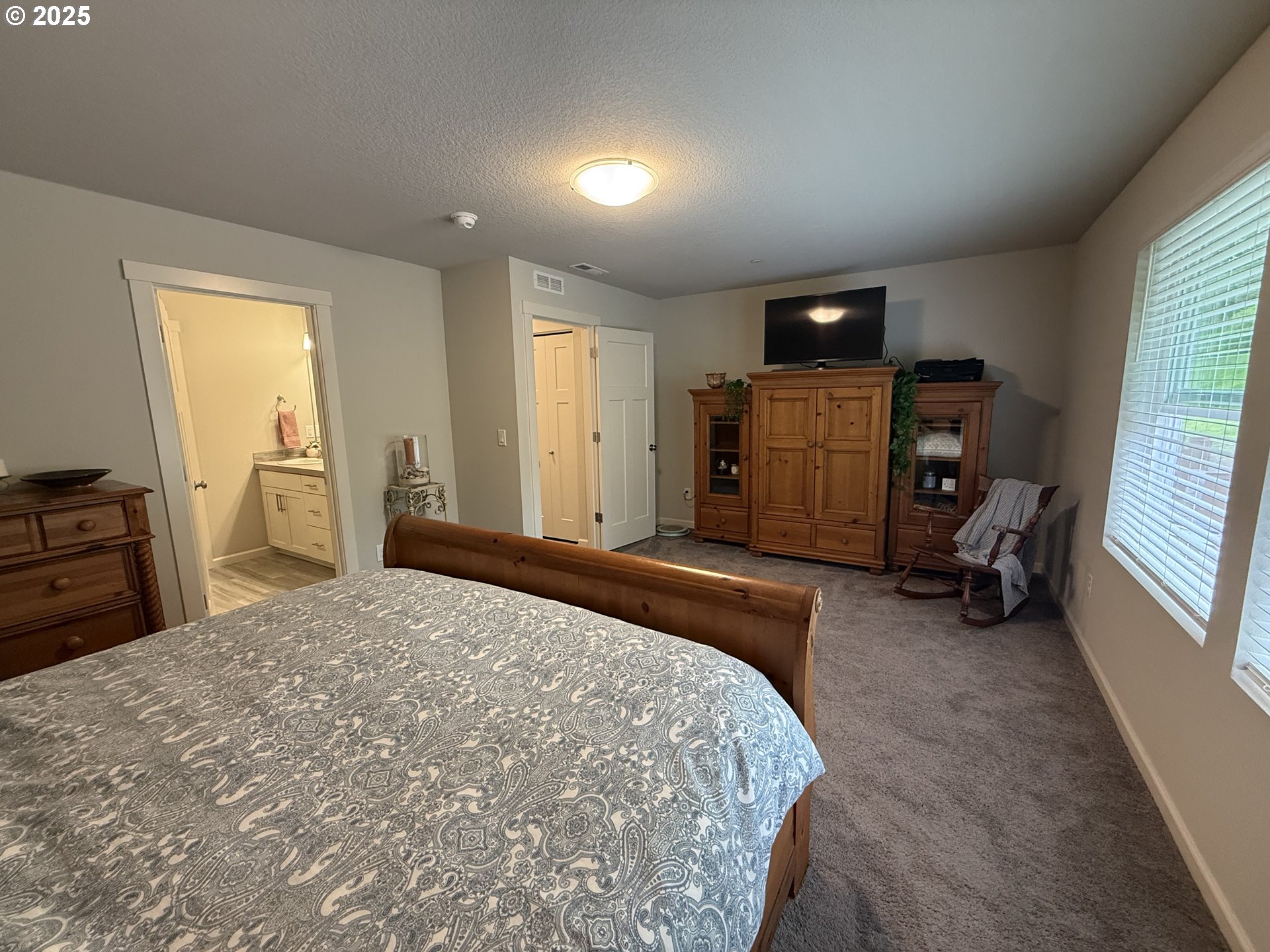 4135 South Canyon View Circle Ridgefield, WA 98642 - Photo 9 of 25 a bedroom with a bed and furniture