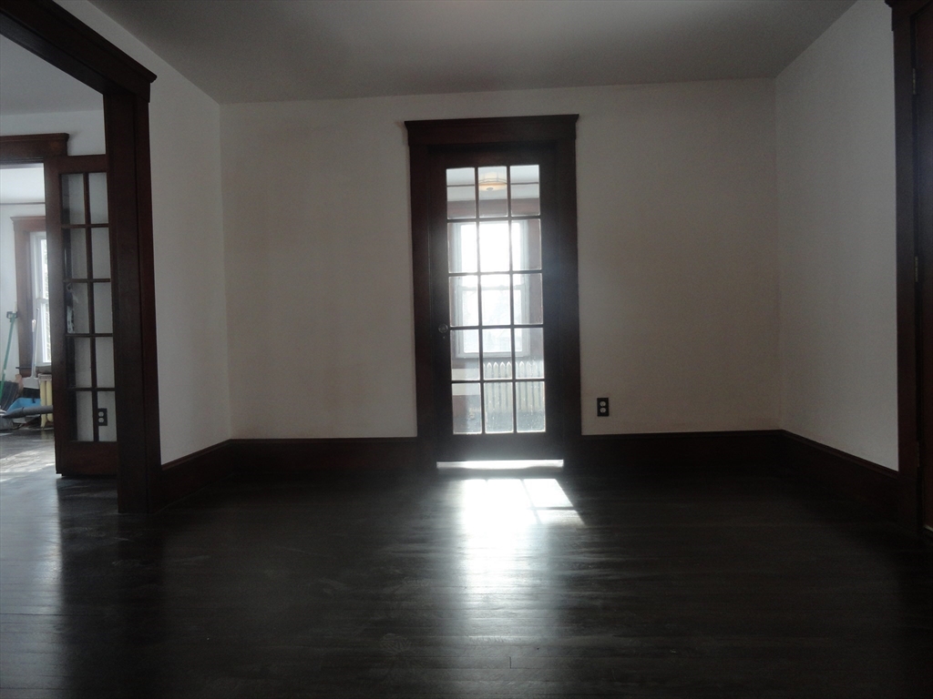 14 Rowe Hill Road Stoneham, MA 02180 - Photo 12 of 30 an empty room with wooden floor and windows