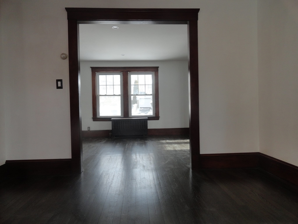 14 Rowe Hill Road Stoneham, MA 02180 - Photo 13 of 30 a view of a livingroom with wooden floor and a window