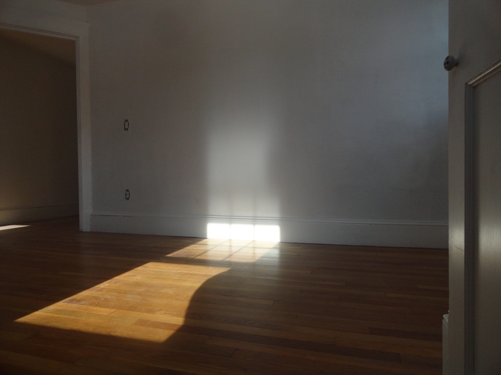 14 Rowe Hill Road Stoneham, MA 02180 - Photo 18 of 30 a view of empty room with wooden floor