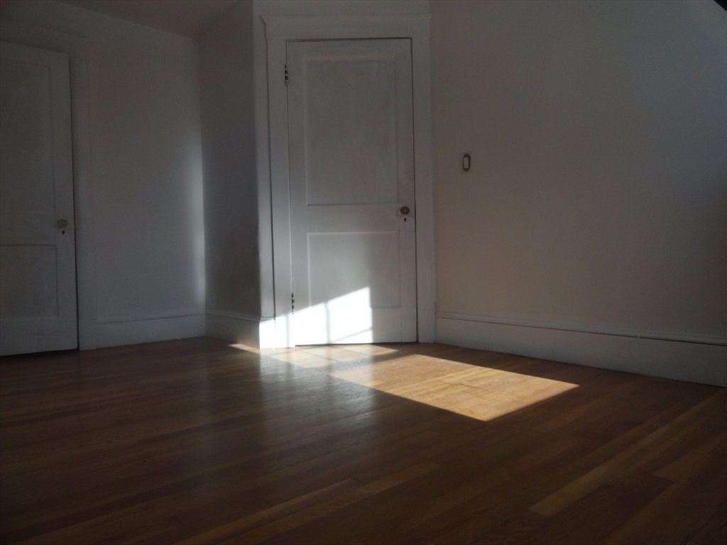 14 Rowe Hill Road Stoneham, MA 02180 - Photo 19 of 30 a view of an empty room with wooden floor