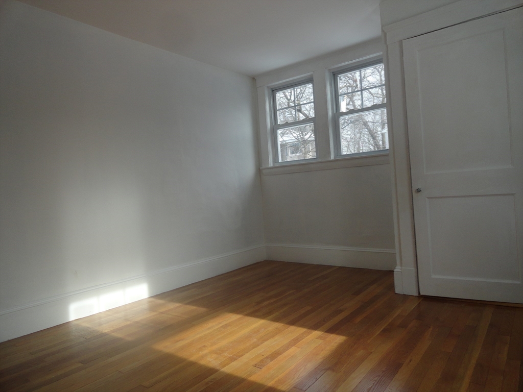 14 Rowe Hill Road Stoneham, MA 02180 - Photo 23 of 30 an empty room with wooden floor and windows