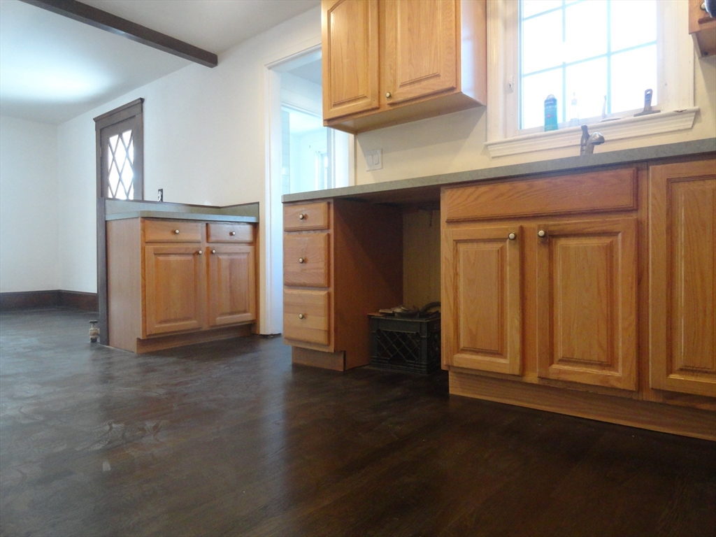 14 Rowe Hill Road Stoneham, MA 02180 - Photo 7 of 30 an empty room with wooden floor and cabinet