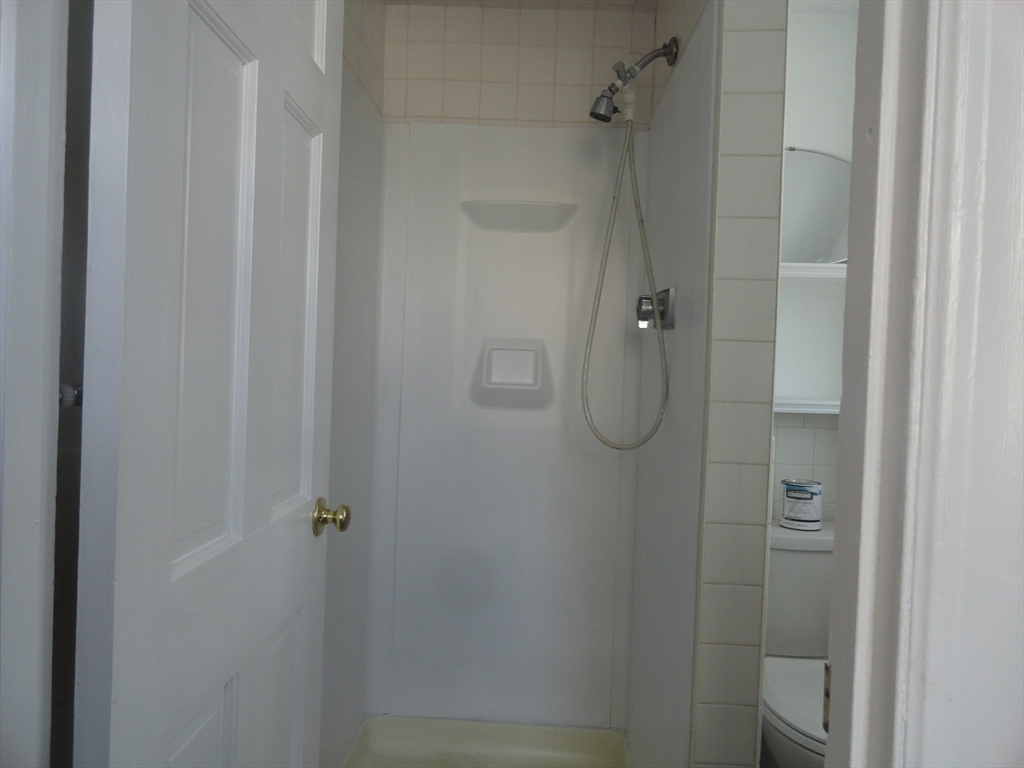 14 Rowe Hill Road Stoneham, MA 02180 - Photo 10 of 30 a bathroom with a glass shower door