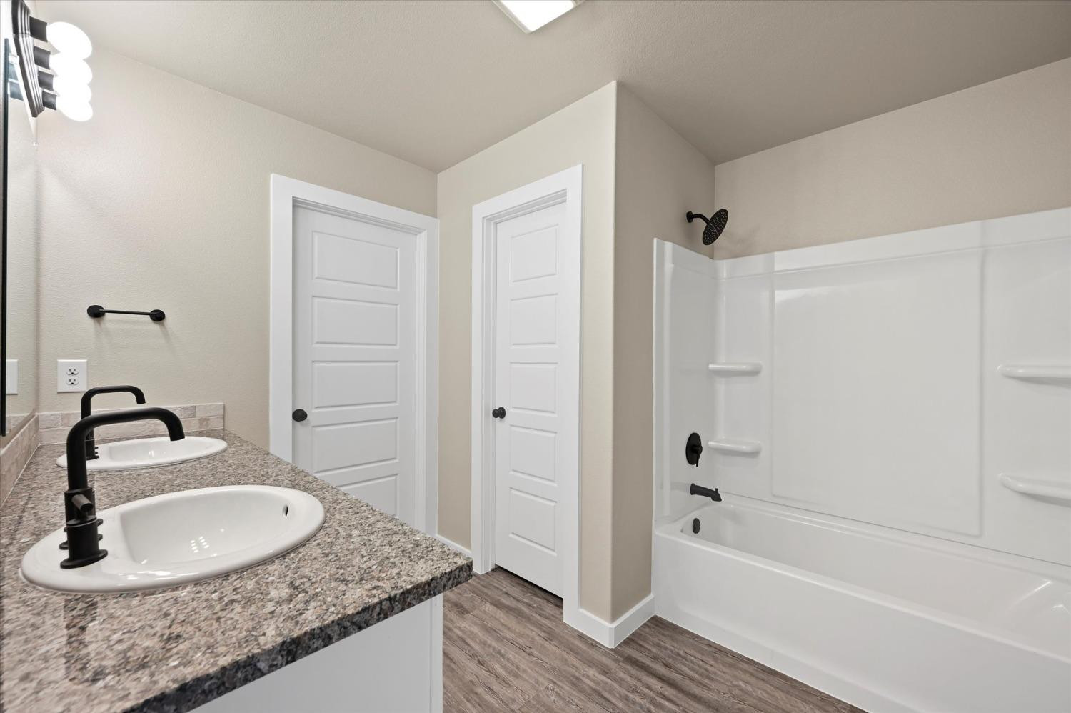 3706 Urbana Place Lubbock, TX 79407 - Photo 14 of 22 a bathroom with a granite countertop tub sink and mirror