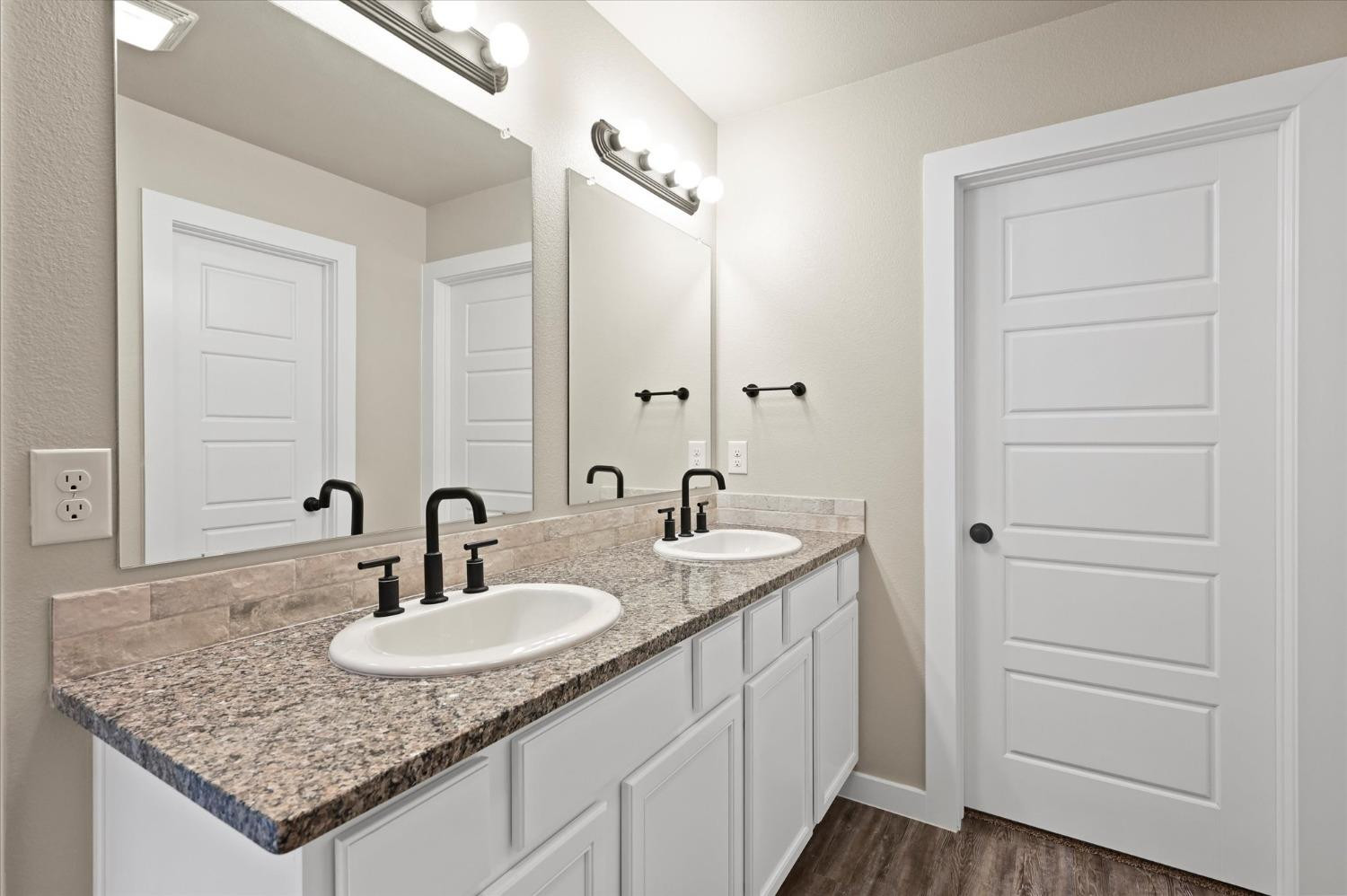 3706 Urbana Place Lubbock, TX 79407 - Photo 15 of 22 a bathroom with a granite countertop sink and a mirror