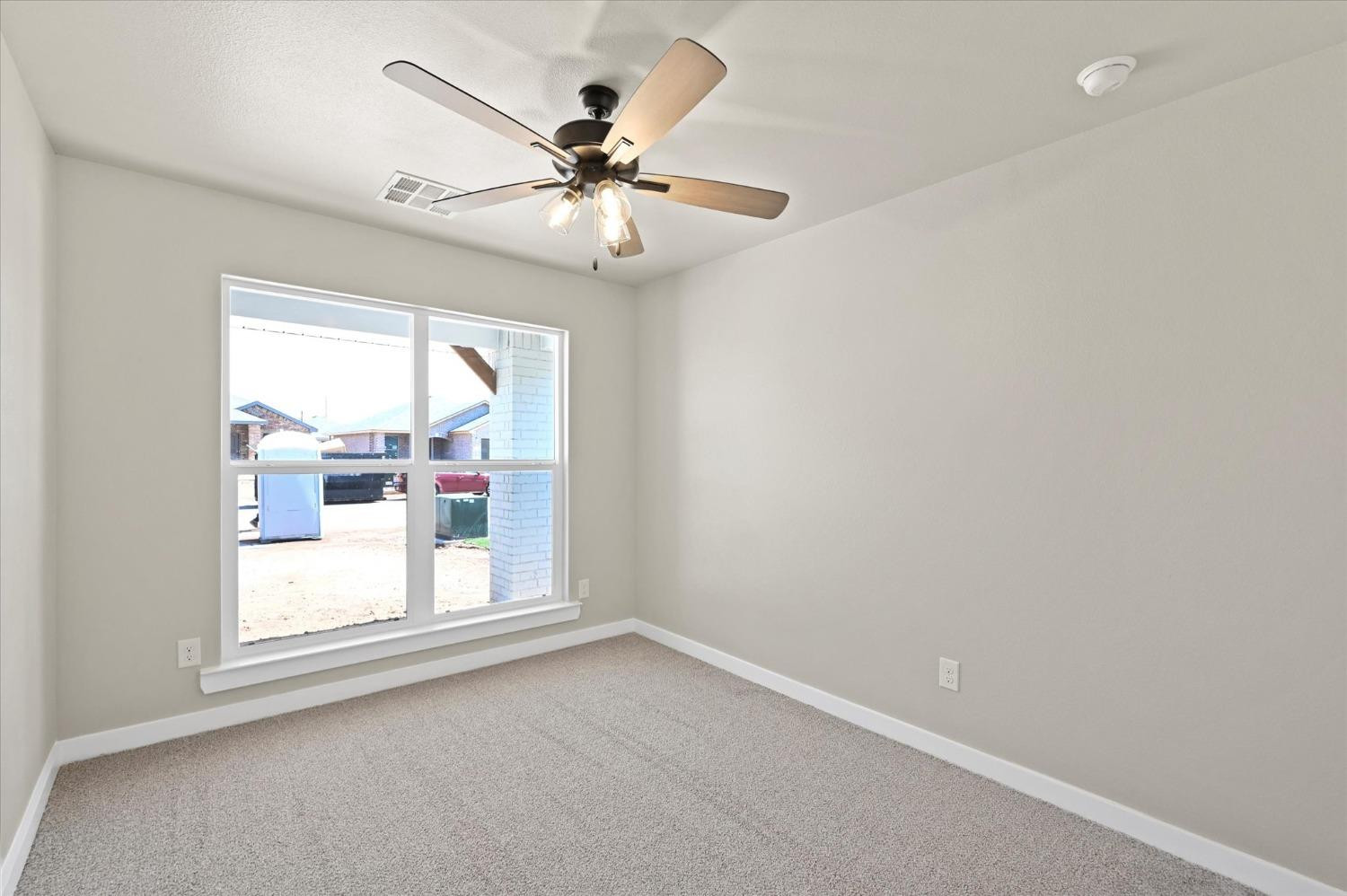 3706 Urbana Place Lubbock, TX 79407 - Photo 17 of 22 an empty room with a window and a fan