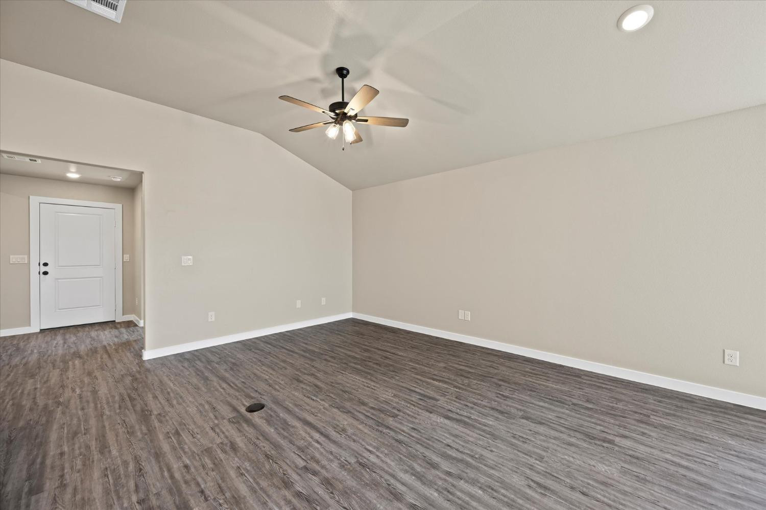 3706 Urbana Place Lubbock, TX 79407 - Photo 7 of 22 a view of an empty room with wooden floor