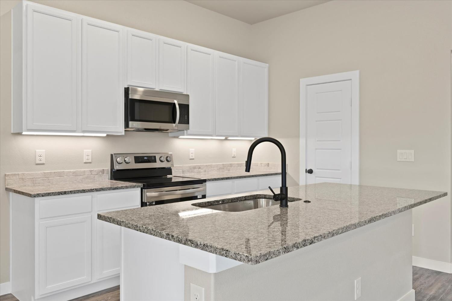 3706 Urbana Place Lubbock, TX 79407 - Photo 8 of 22 a kitchen with granite countertop a sink and a stove top oven