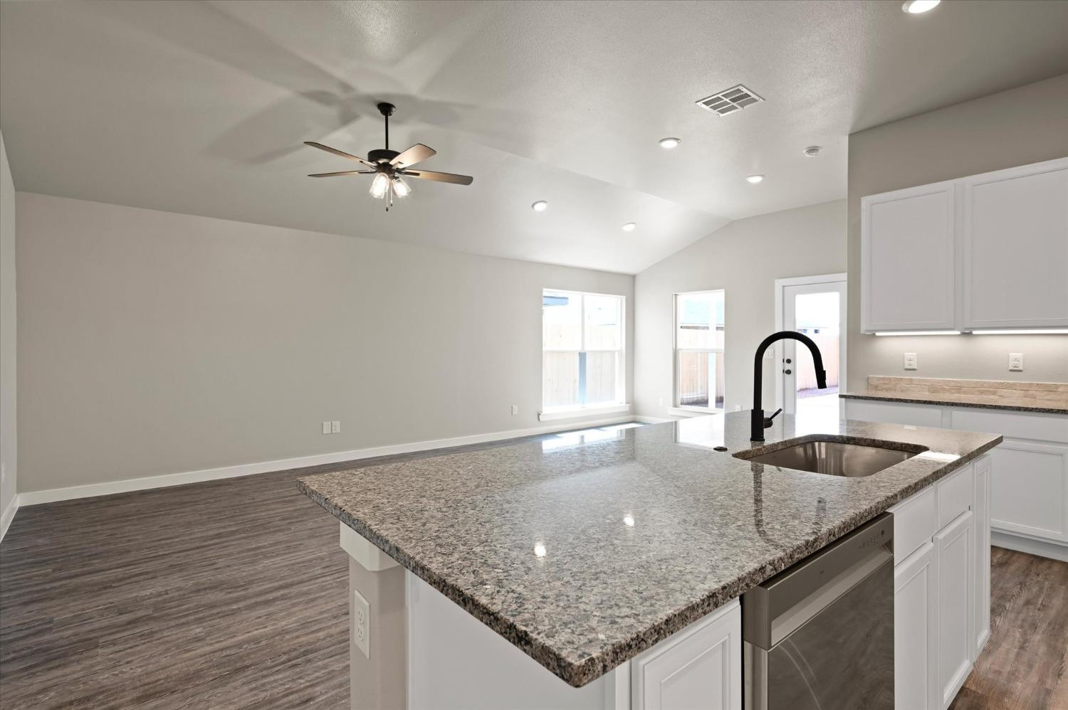3706 Urbana Place Lubbock, TX 79407 - Photo 10 of 22 a kitchen with granite countertop a sink and chandelier