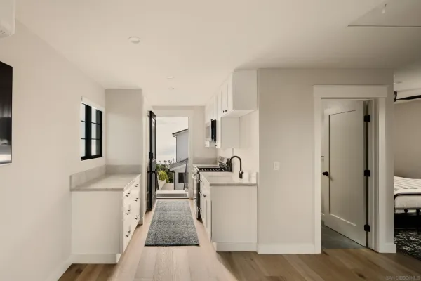 a bathroom with a granite countertop sink a toilet and shower
