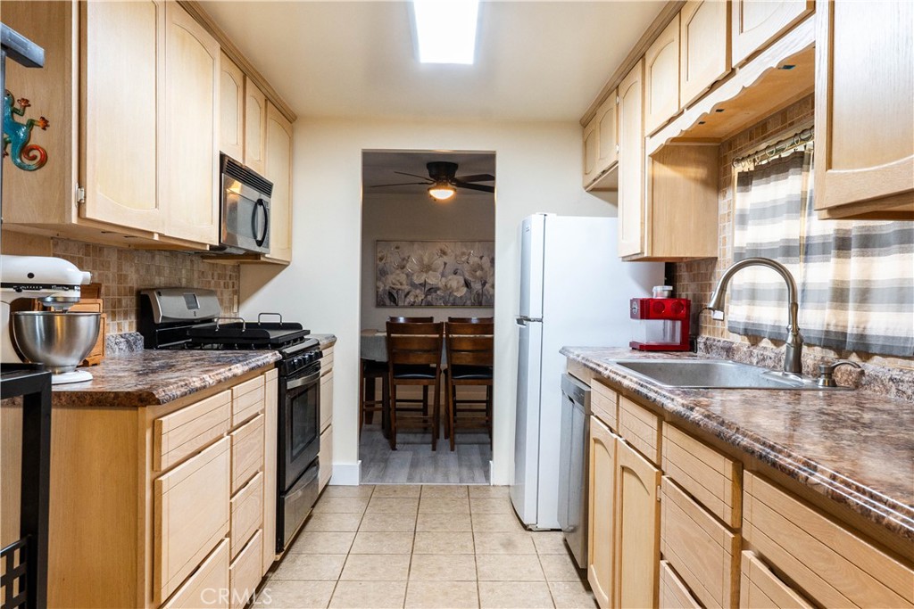 251 South Colorado River Road, Unit 38 Blythe, CA 92225 - Photo 11 of 19 a kitchen with a sink stove and cabinets