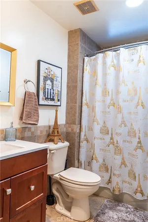 a bathroom with a sink mirror vanity and toilet
