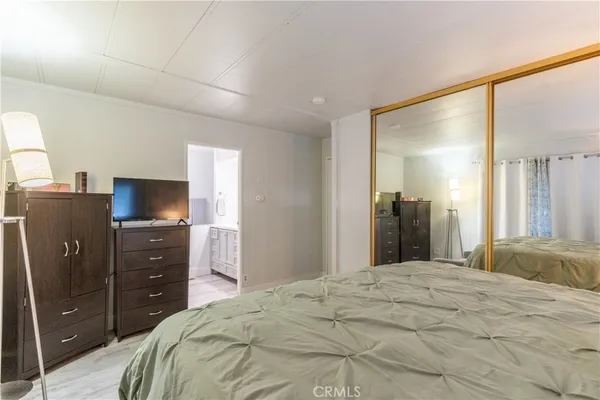 a bedroom with a bed and a television
