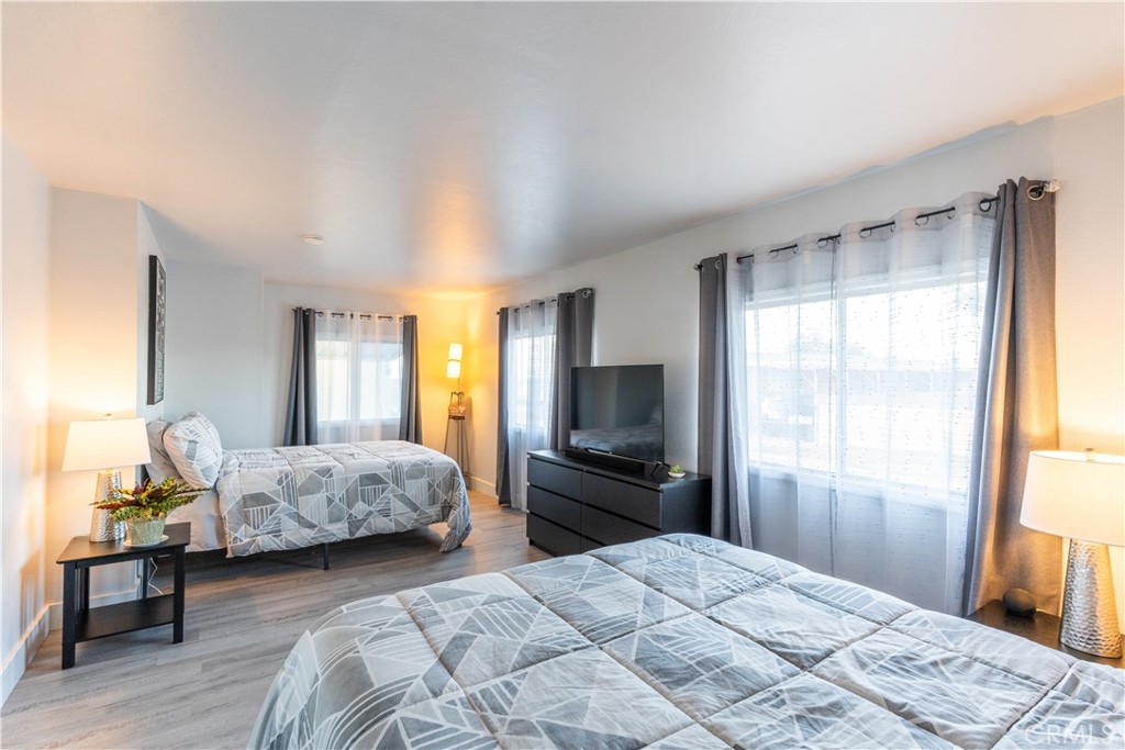 251 South Colorado River Road, Unit 38 Blythe, CA 92225 - Photo 9 of 19 a bedroom with a bed and wooden floor