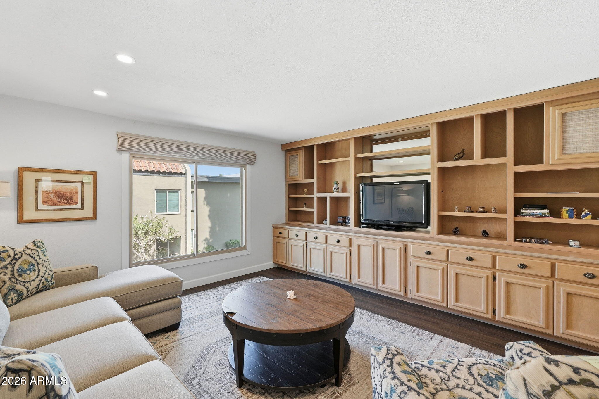 4201 East Camelback Road, Unit 34 Phoenix, AZ 85018 - Photo 9 of 19 a living room with furniture a flat screen tv and kitchen view